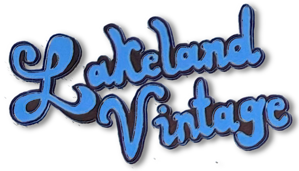 Blue and black 'Lakeland Vintage' logo on a white background